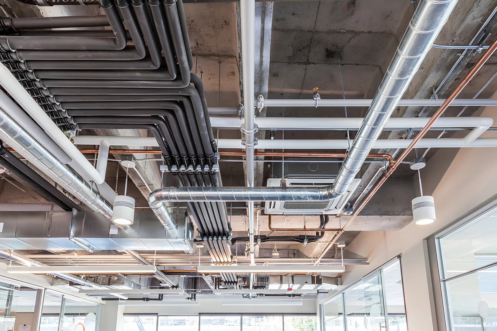 Ductwork and pipework installed at ceiling level